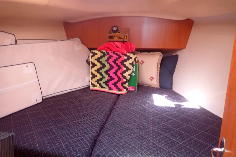 Slide: The Image of Cozy cabin interior of 2008 Hunter 33 sailboat with colorful bedding and cushions. - 23