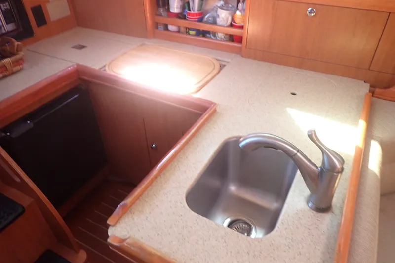 Slide: The Image of Compact kitchen area in a 2008 Hunter 33 sailboat with sink and countertop. - 31