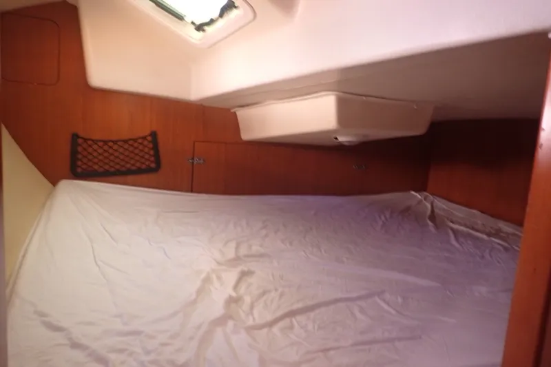 Slide: The Image of Interior cabin of a 2008 Hunter 33 sailboat with a cozy bed setup. - 21