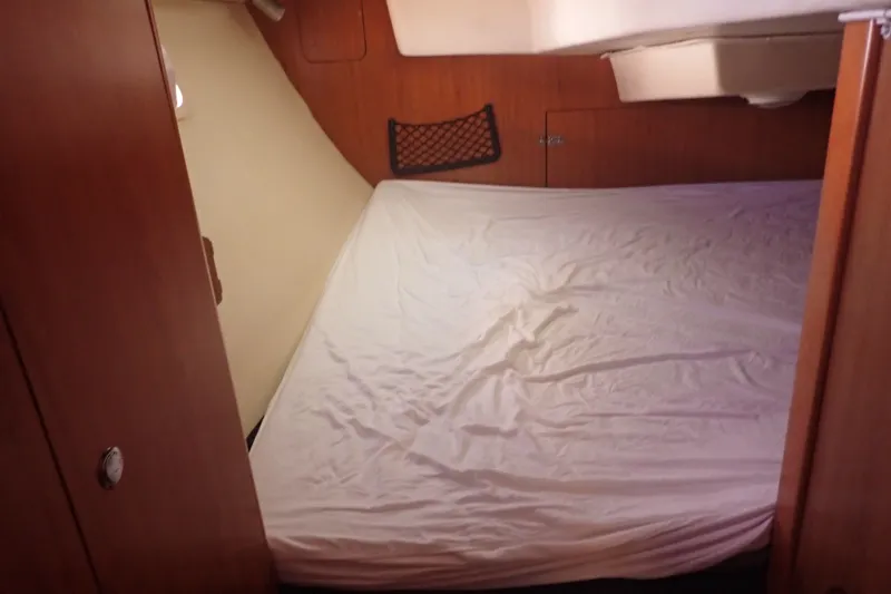 Slide: The Image of Interior cabin of 2008 Hunter 33 sailboat with a neatly made bed. - 20