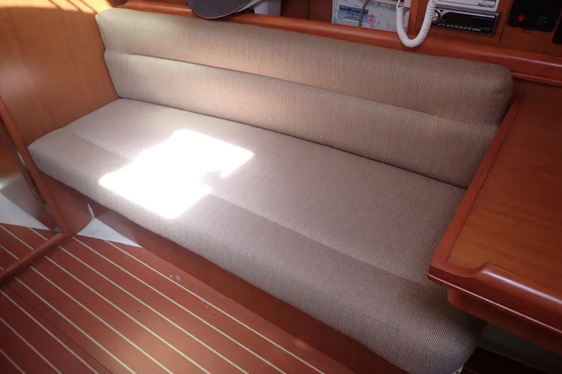 Slide: The Image of Beige cushioned seating in 2008 Hunter 33 sailboat interior with wooden accents. - 28