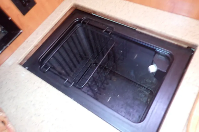 Slide: The Image of Built-in sink with drying rack in 2008 Hunter 33 yacht kitchen. - 32