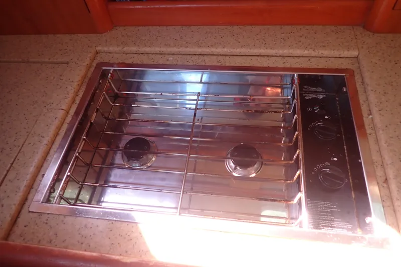 Slide: The Image of Stainless steel stove in 2008 Hunter 33 yacht kitchen, featuring dual burners and control knobs. - 30