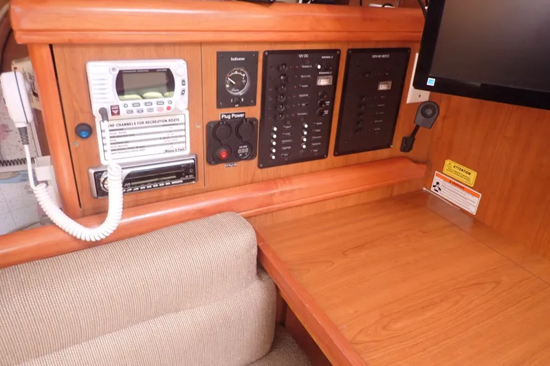 Slide: The Image of Control panel and navigation station inside a 2008 Hunter 33 sailboat. - 16