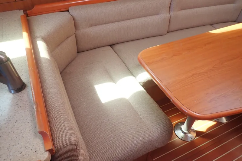 Slide: The Image of Cozy interior of 2008 Hunter 33 sailboat with cushioned seating and wooden table. - 27