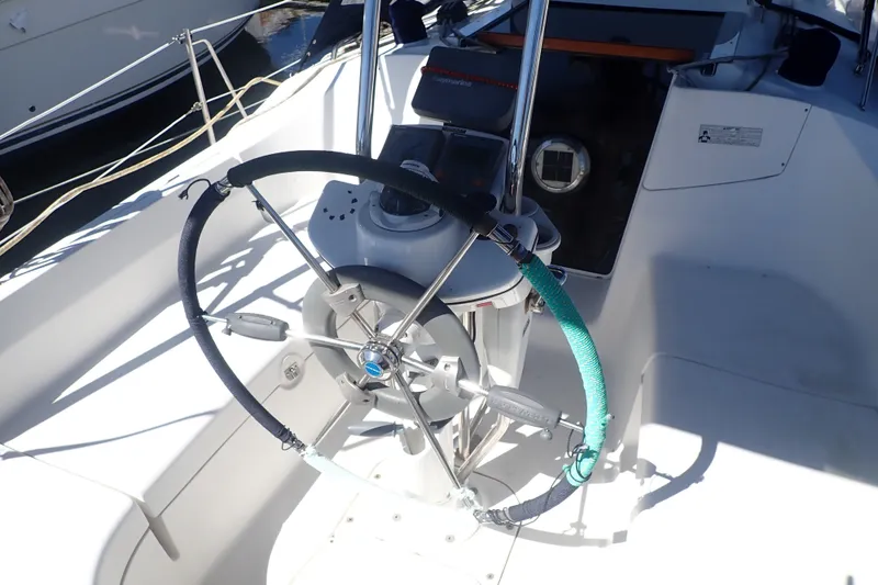 Slide: The Image of 2008 Hunter 33 sailboat cockpit with steering wheel and navigation equipment. - 5