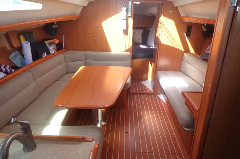 Slide: The Image of Interior of a 2008 Hunter 33 sailboat with wood finish and seating area. - 15