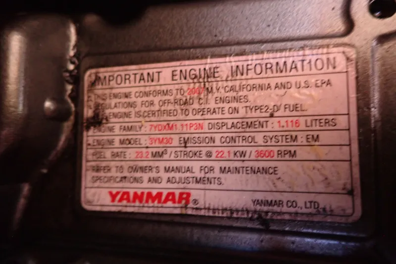 Slide: The Image of Yanmar engine information label on a 2008 Hunter 33, detailing specifications and compliance. - 46