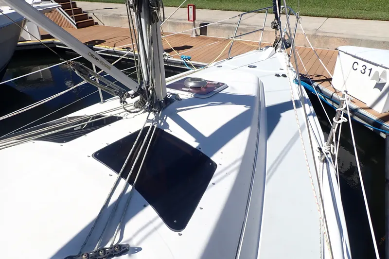 Slide: The Image of 2008 Hunter 33 sailboat docked, showcasing deck and rigging details. - 9