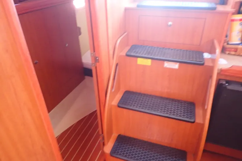 Slide: The Image of Interior of 2008 Hunter 33 sailboat showing wooden stairs and cabin entrance. - 41