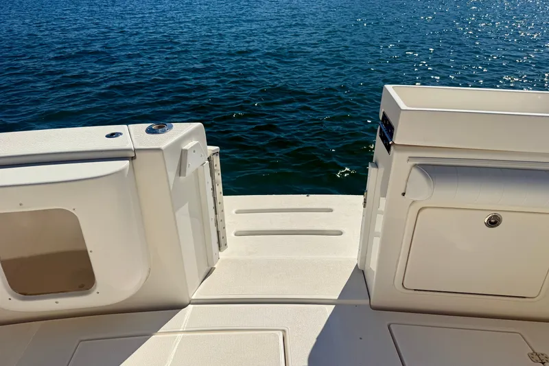 Slide: The Image of 2006 Riviera 40 Flybridge boat deck overlooking calm blue water. - 65