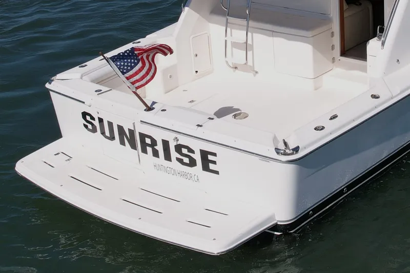 Slide: The Image of 2006 Riviera 40 Flybridge boat named "Sunrise" with American flag, Huntington Harbor, CA. - 9