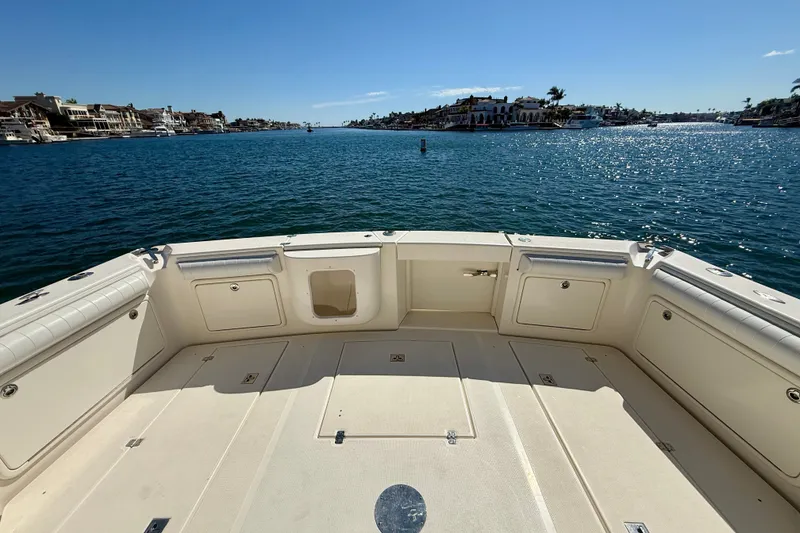 Slide: The Image of 2006 Riviera 40 Flybridge boat deck overlooking serene waterfront and luxury homes. - 61