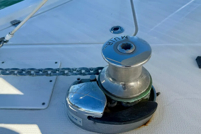 Slide: The Image of Close-up of a 2006 Riviera 40 Flybridge boat's anchor winch and chain on deck. - 73