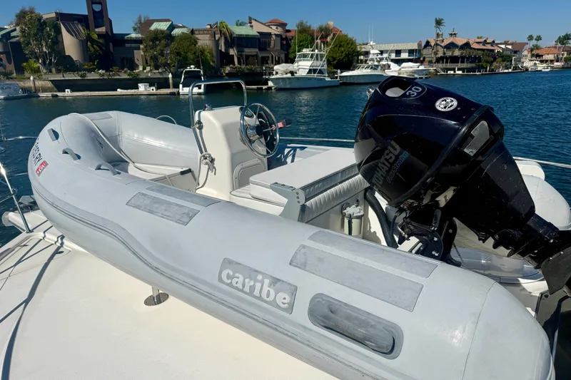 Slide: The Image of Inflatable boat with Tohatsu motor on 2006 Riviera 40 Flybridge yacht, docked in marina. - 67