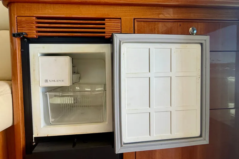 Slide: The Image of Open U-Line ice maker on 2006 Riviera 40 Flybridge yacht, showcasing interior compartment. - 34