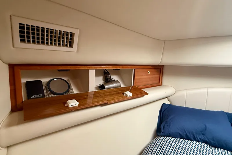 Slide: The Image of Interior cabin of 2006 Riviera 40 Flybridge yacht with storage and bedding. - 42