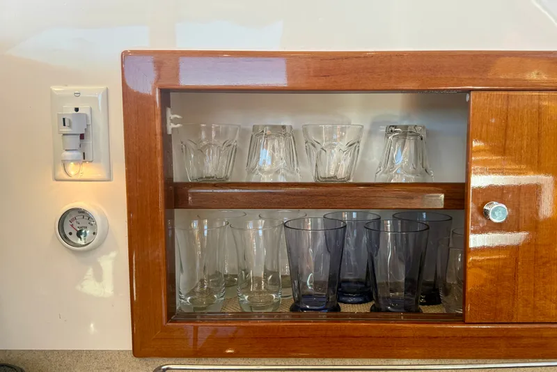 Slide: The Image of Wooden cabinet with glassware on a 2006 Riviera 40 Flybridge yacht. - 36