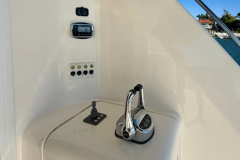 Slide: The Image of Control panel of a 2006 Riviera 40 Flybridge yacht with throttle and joystick. - 58