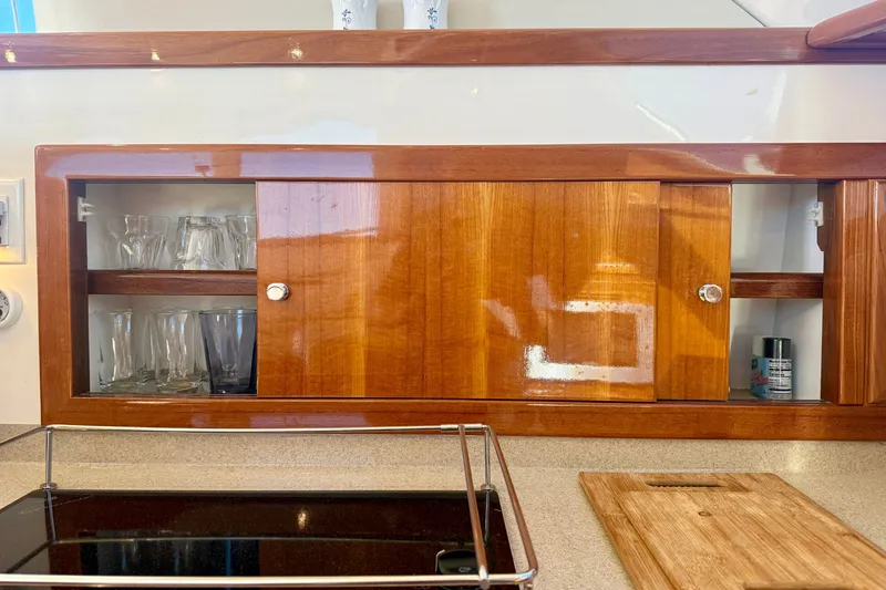 Slide: The Image of Wooden cabinet with glassware in a 2006 Riviera 40 Flybridge yacht kitchen. - 35