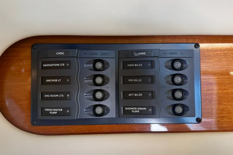 Slide: The Image of Control panel on 2006 Riviera 40 Flybridge yacht with labeled switches for various functions. - 30