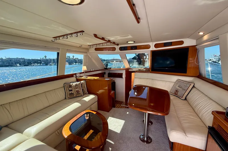 Slide: The Image of Luxurious interior of 2006 Riviera 40 Flybridge yacht with elegant seating and waterfront view. - 12