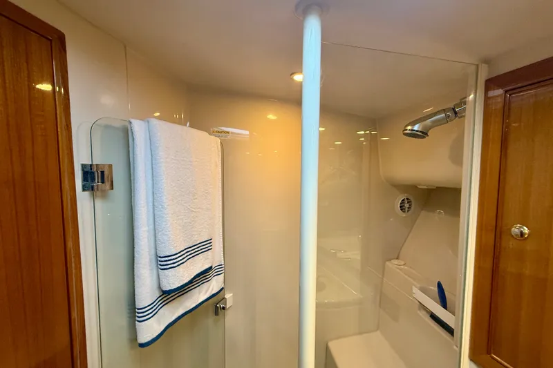 Slide: The Image of Bathroom interior of 2006 Riviera 40 Flybridge yacht with shower and towel. - 48