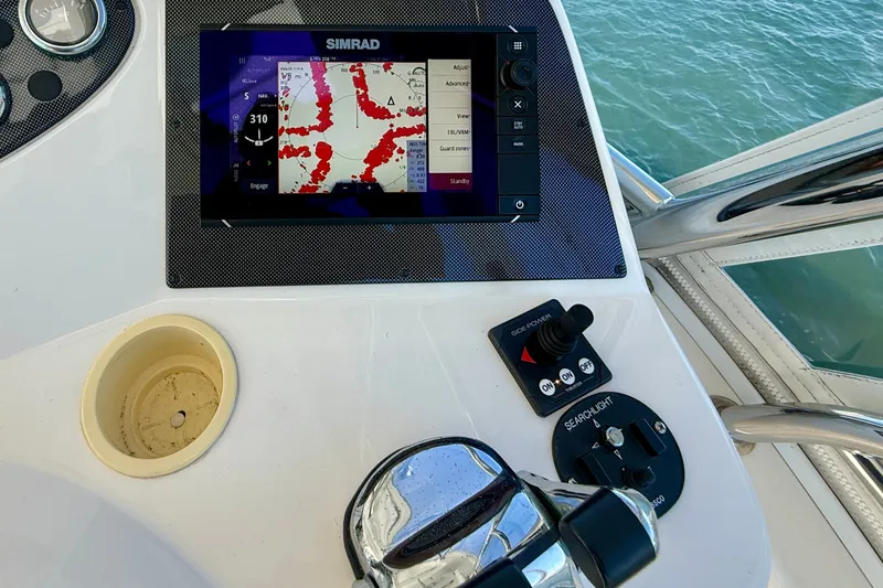 Slide: The Image of Control panel of a 2006 Riviera 40 Flybridge with navigation display and controls. - 81