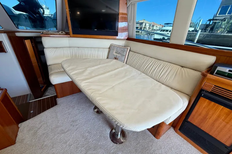Slide: The Image of Interior of 2006 Riviera 40 Flybridge yacht with plush seating and table. - 16