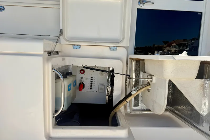 Slide: The Image of Compartment of 2006 Riviera 40 Flybridge yacht showing control panel and storage. - 92