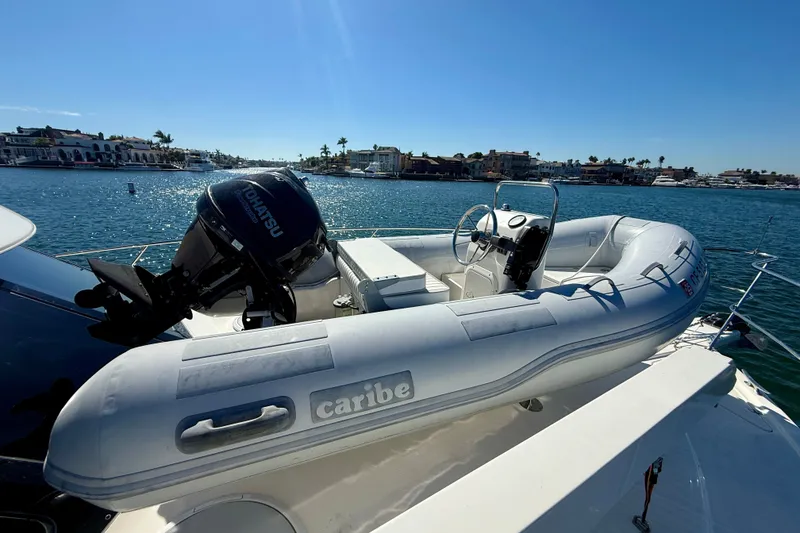 Slide: The Image of Inflatable boat with Tohatsu motor on 2006 Riviera 40 Flybridge yacht, docked in sunny marina. - 71