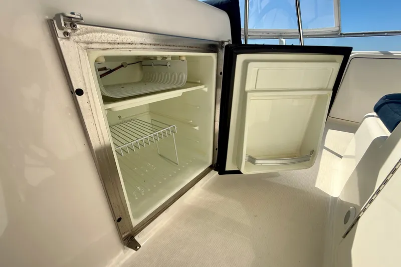 Slide: The Image of Open refrigerator on 2006 Riviera 40 Flybridge yacht, showcasing interior shelves. - 87