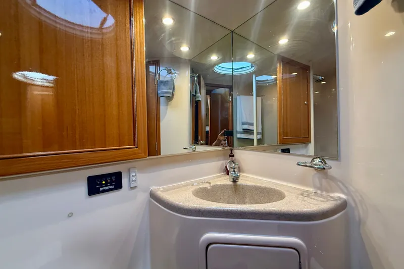 Slide: The Image of Luxurious bathroom in 2006 Riviera 40 Flybridge yacht with mirrored walls and modern fixtures. - 47