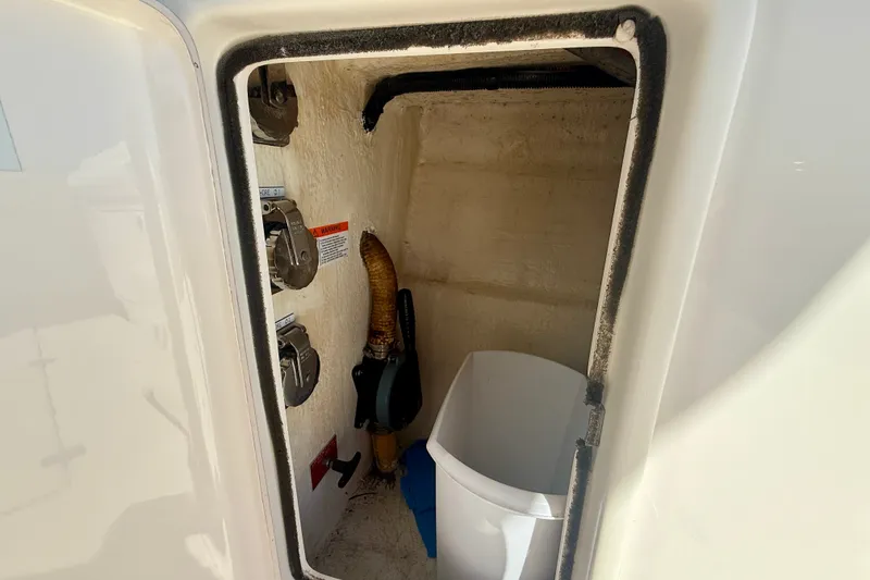 Slide: The Image of Storage compartment on a 2006 Riviera 40 Flybridge boat, featuring utility controls and equipment. - 63