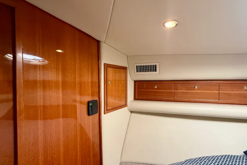 Slide: The Image of Interior of 2006 Riviera 40 Flybridge yacht with wood paneling and storage cabinets. - 44