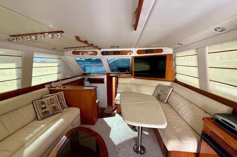 Slide: The Image of Luxurious interior of a 2006 Riviera 40 Flybridge yacht with elegant seating and modern amenities. - 14