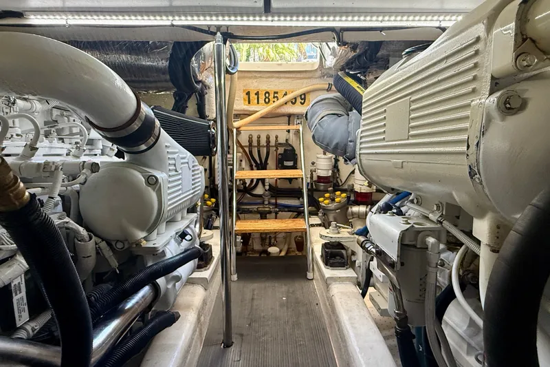 Slide: The Image of Engine room of a 2006 Riviera 40 Flybridge yacht, showcasing machinery and equipment. - 98