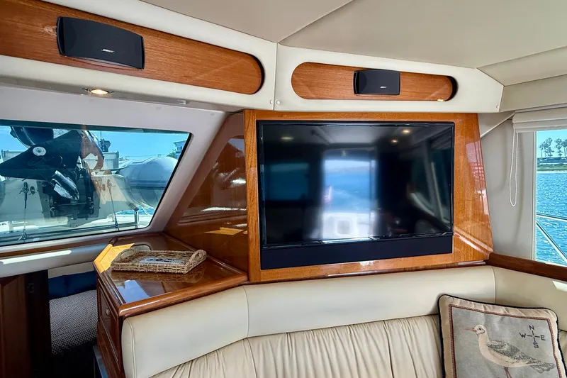 Slide: The Image of Luxurious interior of 2006 Riviera 40 Flybridge yacht with TV and elegant wood finish. - 20