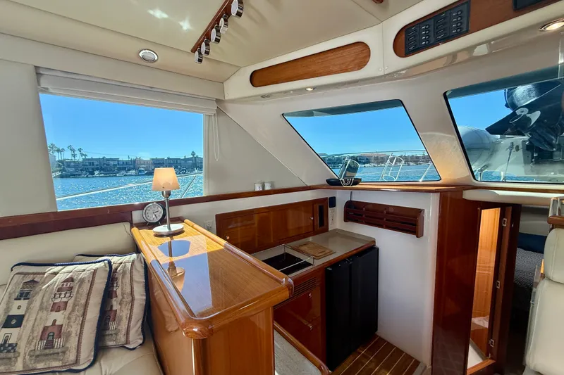 Slide: The Image of Interior of 2006 Riviera 40 Flybridge yacht with elegant wood finish and waterfront view. - 23