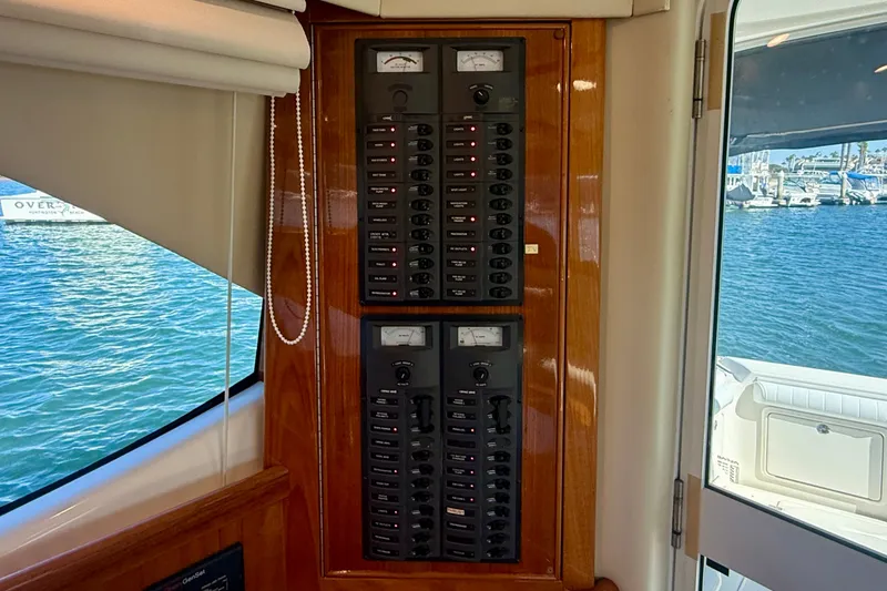 Slide: The Image of Electrical panel inside a 2006 Riviera 40 Flybridge yacht, overlooking marina waters. - 28