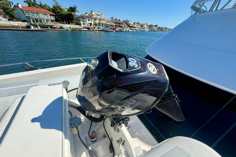Slide: The Image of 2006 Riviera 40 Flybridge with outboard motor, docked near waterfront homes. - 69