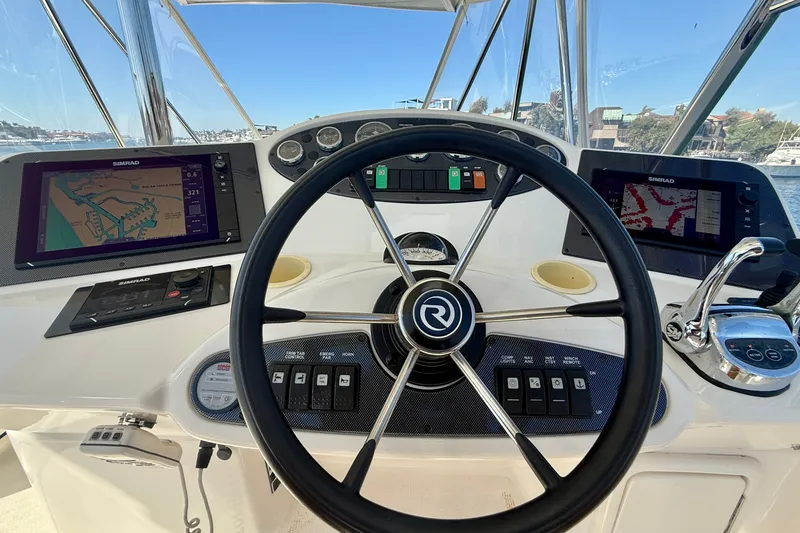 Slide: The Image of Helm of 2006 Riviera 40 Flybridge with navigation screens and controls. - 84