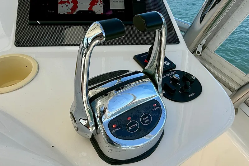 Slide: The Image of Control panel of a 2006 Riviera 40 Flybridge yacht with throttle and navigation controls. - 82