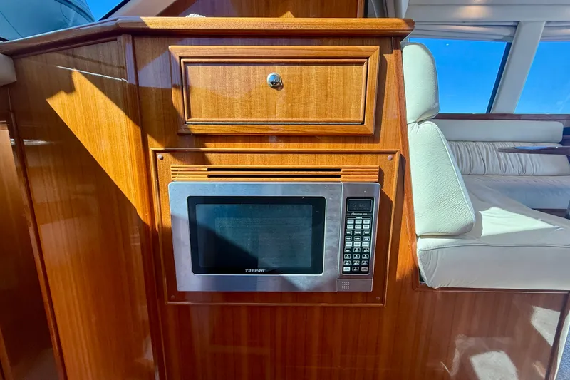 Slide: The Image of Wooden interior of 2006 Riviera 40 Flybridge with built-in microwave and seating area. - 38
