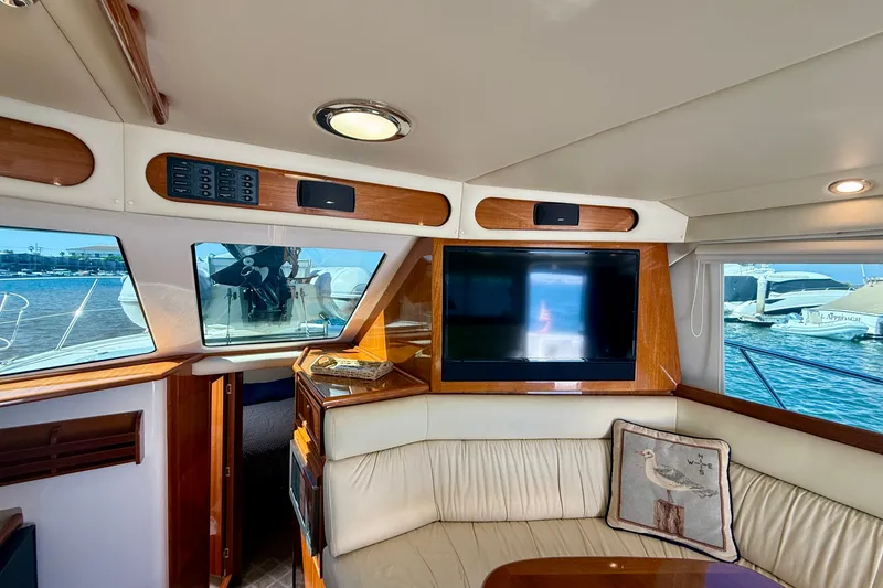 Slide: The Image of Luxurious interior of 2006 Riviera 40 Flybridge yacht with plush seating and large window views. - 15