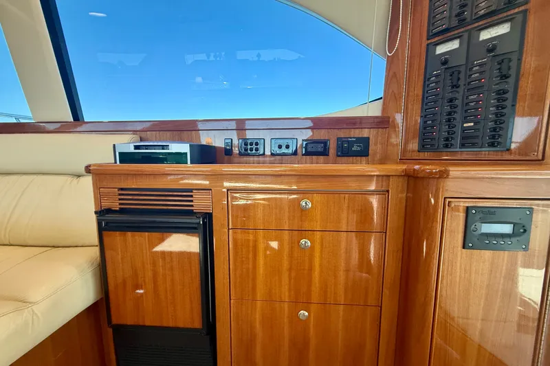 Slide: The Image of Interior of 2006 Riviera 40 Flybridge yacht with wooden cabinetry and control panels. - 32