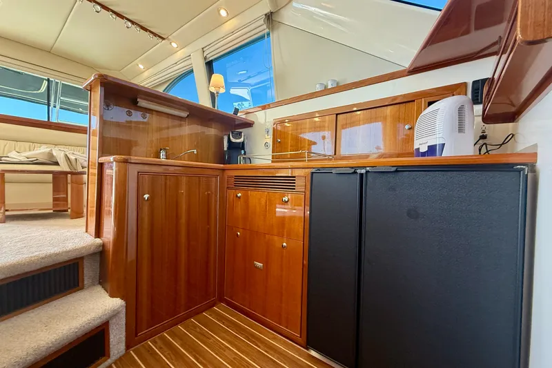 Slide: The Image of Luxurious 2006 Riviera 40 Flybridge yacht interior with elegant wood cabinetry and modern amenities. - 25