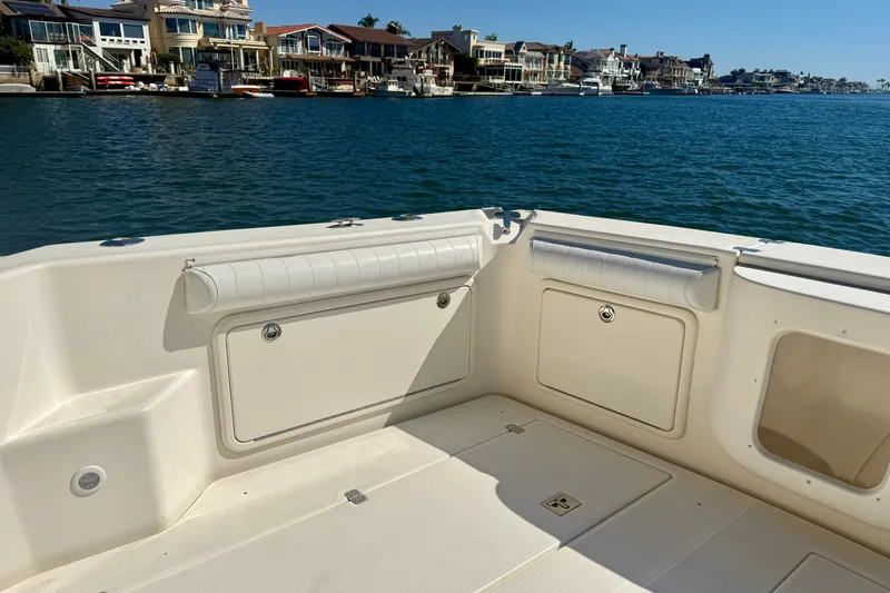 Slide: The Image of 2006 Riviera 40 Flybridge boat deck with waterfront view and luxury homes. - 64