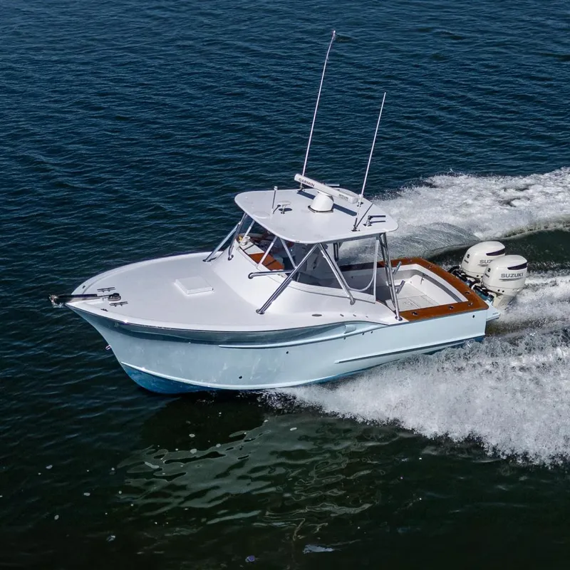 Slide: The Image of 2019 Custom Carolina Custom Express boat cruising on open water. - 0