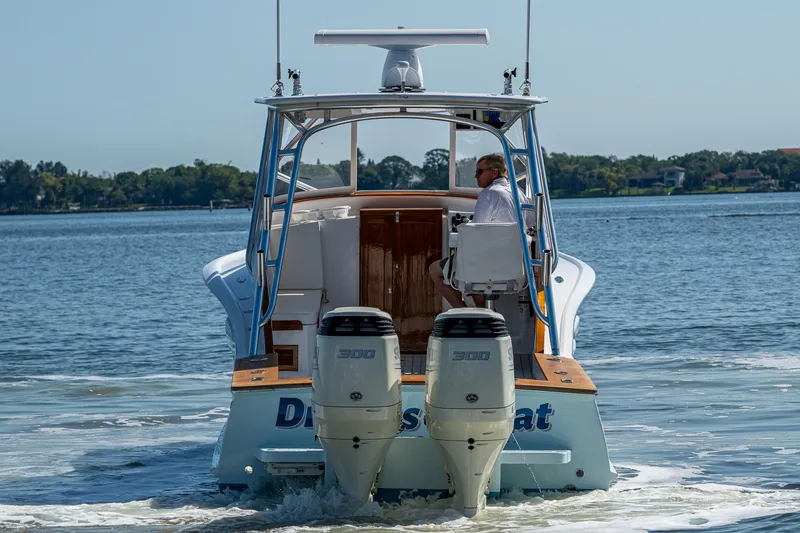 Slide: The Image of 2019 Custom Carolina Custom Express boat cruising on a calm lake. - 41